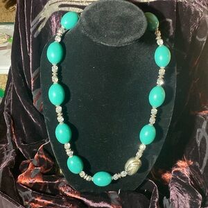 Adjustable 14”-16” beautiful turquoise and silver toned beaded necklace.